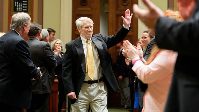 In this Thursday, April 9, 2015, photo, former Minnesota Gov. Wendell Anderson arrives in the House Chamber to a rousing applause before present Gov. Mark Dayton delivers his 2015 State of the State address in the House Chamber of the Minnesota State Capitol, in St. Paul.