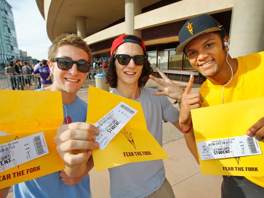 ASU fans show off their football tickets.