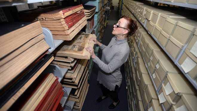 Laura McLeMore checks a bound book of old Shreveport Times papers stored at the LSUS Archive. A leaking roof in a nearby office has caused concern with the staff on the safety of their archives.LSUS Archive