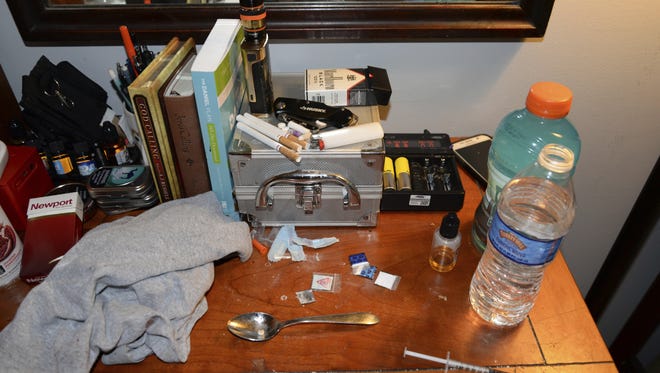 This Sunday, May 21, 2017, photo provided by the Chester County District Attorney's Office in West Chester, Pa., shows opioid drug packets, a syringe and other belongings found by law enforcement personnel in an addiction counselor's bedroom at the Freedom Ridge Recovery Lodge, a suburban Philadelphia halfway house in West Brandywine Township, Pa. Two men working as addiction counselors at the halfway house died of opioid overdoses inside the facility and were found by residents on Sunday, authorities announced Wednesday, May 24, 2017. (Chester County District Attorney's Office via AP)