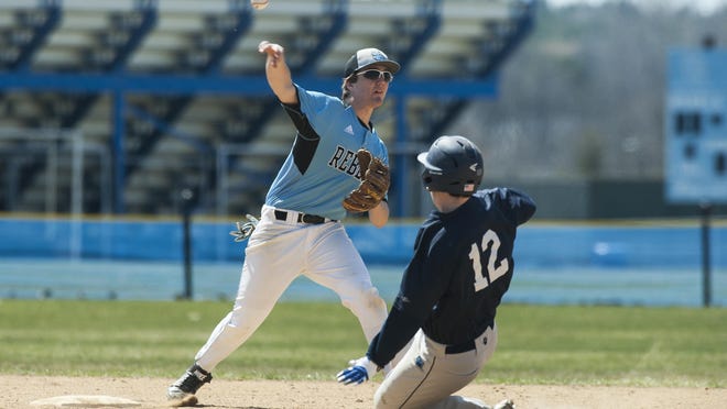 South Burlington’s Tobias Young, left, completes the double play as MMU’s Josh Springer (12) slides into second base during the high school baseball game between the Mount Mansfield Cougars and the South Burlington Rebels at South Burlington High School on Saturday.