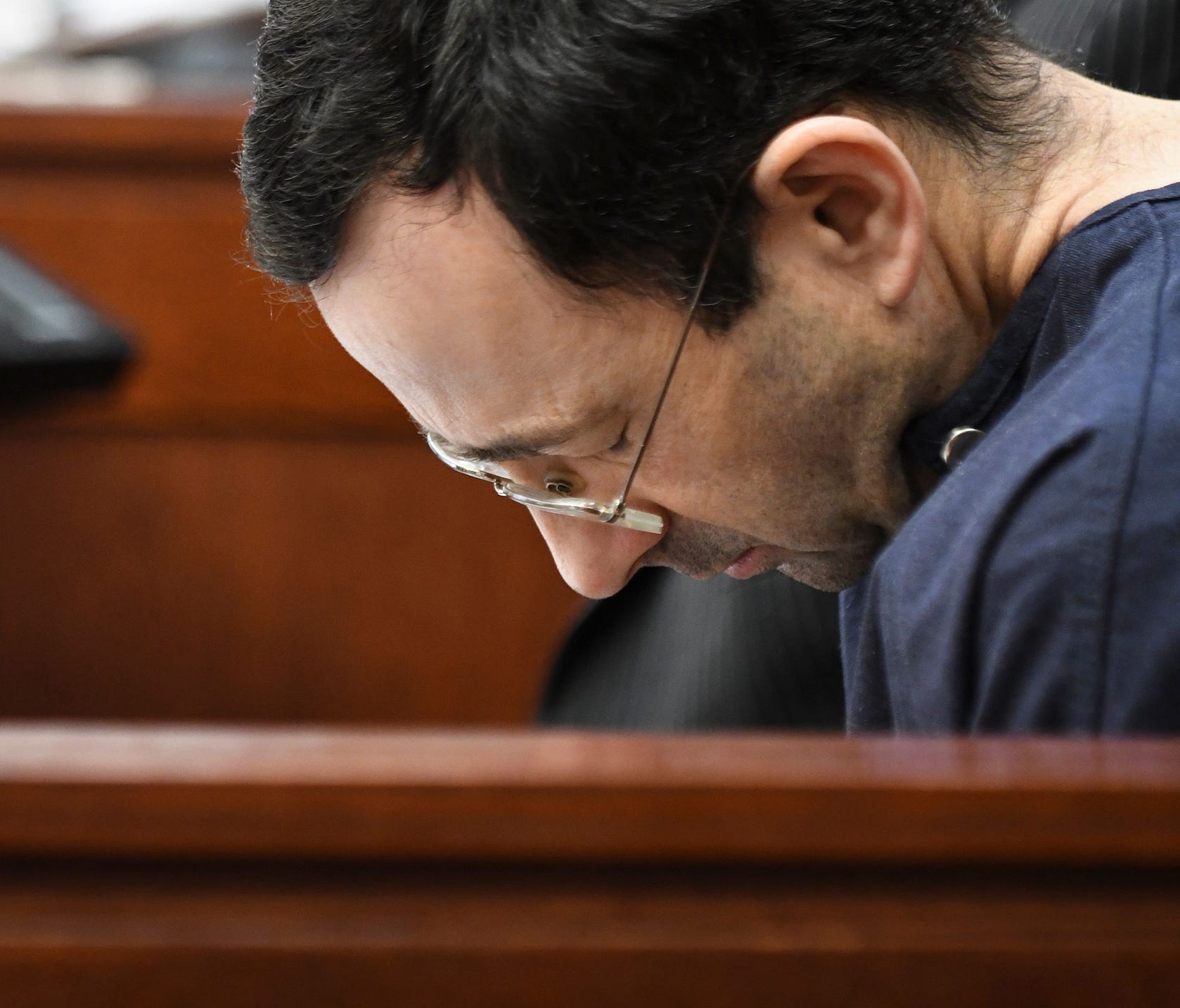 Larry Nassar hangs his head as former gymnast Amanda Thomashow gives her victim statement Tuesday, Jan. 23, 2018, during the sixth day of victim-impact statements in Ingham County (Mich.) Circuit Court.