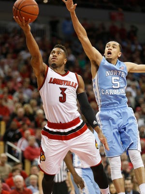 Louisville's Trey Lewis beats UNC's Marcus Paige off the dribble and scores on a layup late in the game. Feb. 1, 2016.