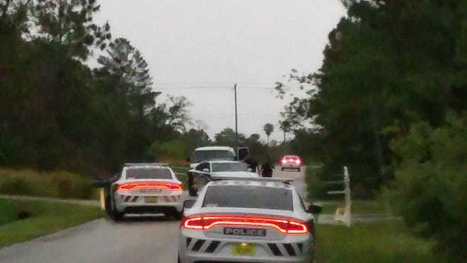 Police converge on Ricardo Street, SE, in Palm Bay as part of the investigation.