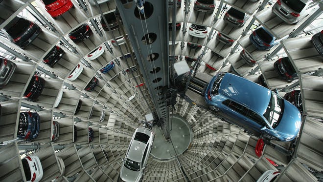 New passenger cars of German automaker Volkswagen AG await their new owners in one of the twin car towers at the Volkswagen factory on April 28, 2016 in Wolfsburg, Germany.