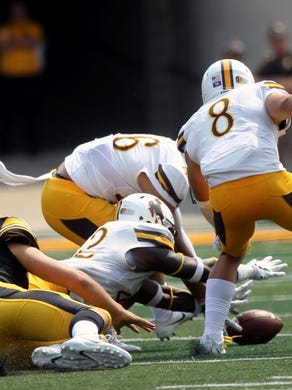 Iowa quarterback Nate Stanley loses the ball during the Hawkeyes' game against Wyoming at Kinnick Stadium on Saturday, Sept. 2, 2017.