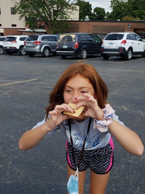 Pearl City Schools students recently resumed their education with the start of the 2020-21 school year. Pictured: Aubrianna Mefford eating a s'more made with the solar oven science project.