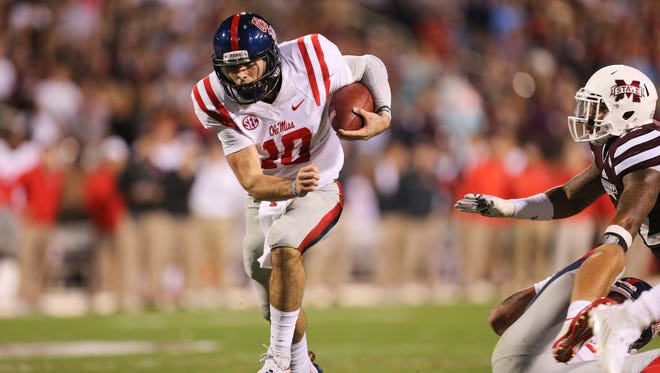 Ole Miss quarterback Chad Kelly finds a hole in the MSU defense in the first quarter of Saturday's Egg Bowl in Starkville.