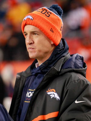 Denver Broncos injured quarterback Peyton Manning watches from the sidelines prior to an NFL football game against the Cincinnati Bengals on Monday.