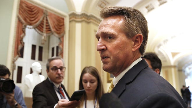 Sen. Jeff Flake chats with reporters on Capitol Hill in Washington.