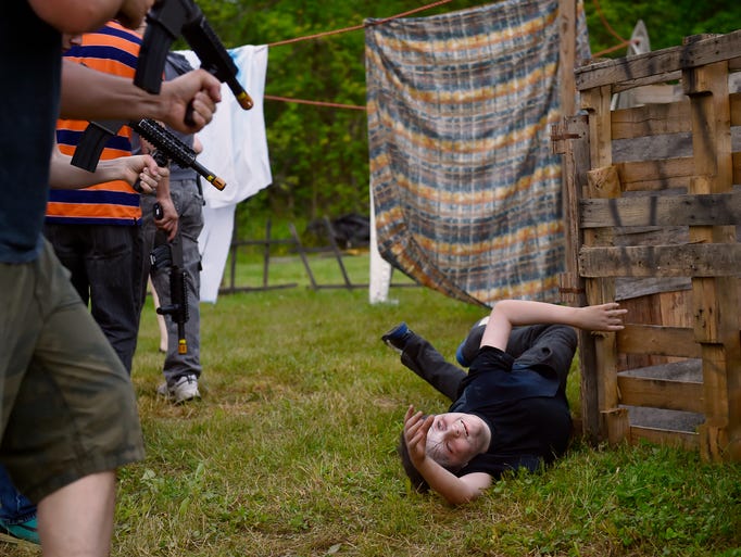 Cole Firestone, 13, plays a just-shot zombie in a Zombie