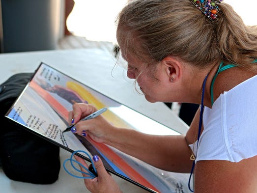 Carol Dowdy-Dodd signs a poster of Vern and Lauren