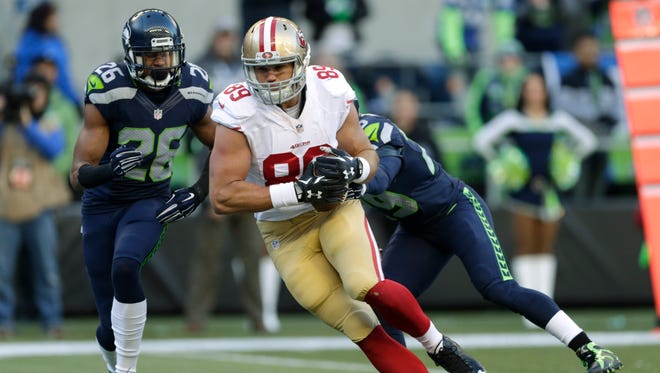 San Francisco 49ers tight end Vance McDonald (89) runs for a touchdown past Seattle Seahawks cornerback Cary Williams, left, and free safety Earl Thomas, right, in the first half of an NFL football game, Sunday, Nov. 22, 2015, in Seattle.