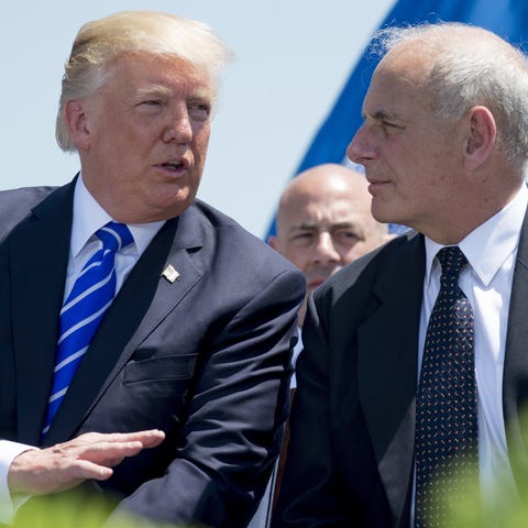 President Trump speaks with John Kelly.