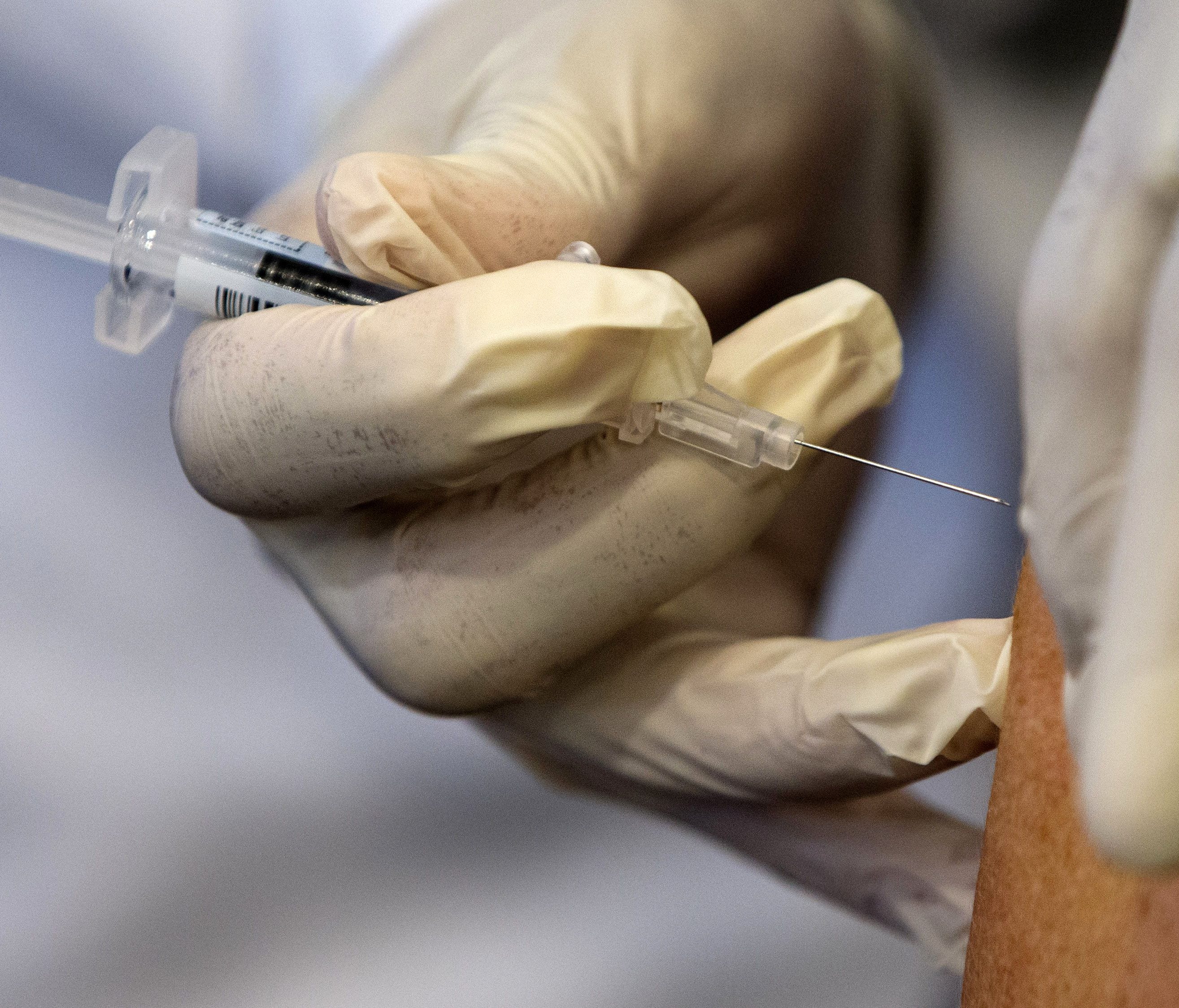 A nurse administers a flu vaccine shot in Washington. Medical expenses are a burden whenever they hit, but a recent study found they're most common around the first few months of the year.