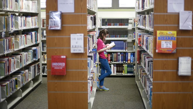 Aries-Nicole Marie Taylor, 12, reads a classic mythological book at Jefferson County R.J. Bailor Public Library in Monticello. The library has undergone over $100,000 in renovations this year.