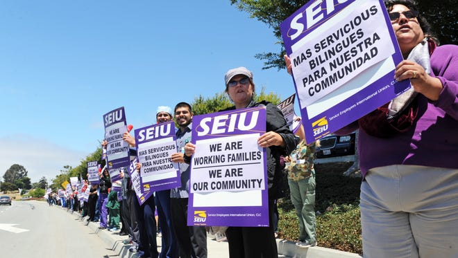 Members of SEIU Local 521 march on Wednesday in front of Natividad Medical Center in Salinas. Their contract with Monterey County expires June 30th.  