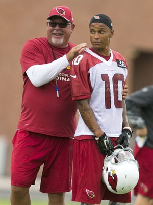 Cardinals head football coach Bruce Arians laughs alongside wide receiver Brittan Golden during minicamp on June 9, 2015.