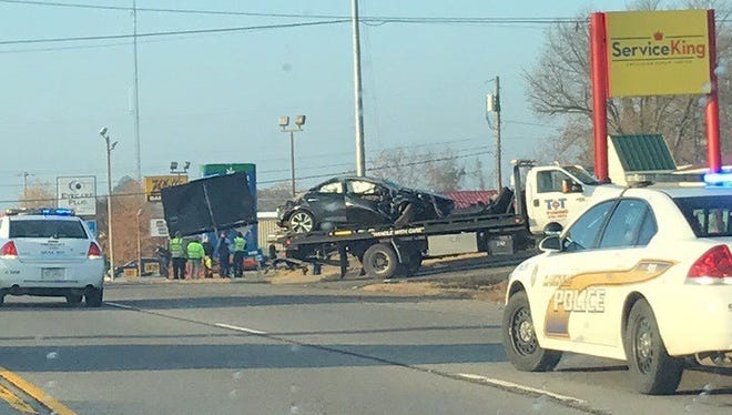 Crews remove the vehicle from the scene of a fatal wreck on Wilma Rudolph Boulevard Wednesday morning.