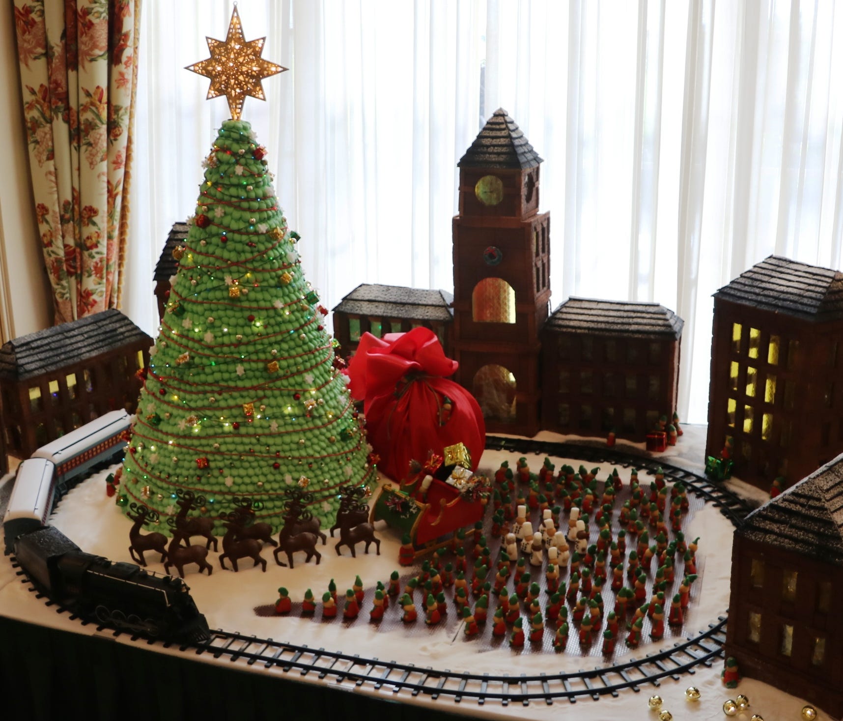 At The Sanctuary at Kiawah Island Golf Resort in South Carolina, executive pastry chef Remy Funfrock's gingerbread display is inspired by Santa's village in 'The Polar Express'. Made with more than 800 pieces of gingerbread, the scene features 250 el