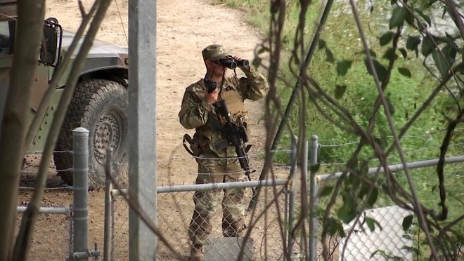 FILE - In this April 10, 2018, file frame from video, a National Guardsman watches over Rio Grande River on the border in Roma, Texas. The governors of multiple East Coast states have announced that they will not deploy National Guard resources near the U.S.-Mexico border, a largely symbolic but politically significant rejection of the Trump administrationâs âzero-toleranceâ immigration policy that has resulted in children being separated from their families. (AP Photo/John Mone, File)