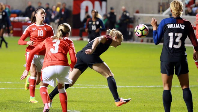 Samantha Mewis heads the ball past teammate Lynn Wiliams and into the back of the net during the second half of the United States national team's 4-0 win over Switzerland at Rio Tinto Stadium in Sandy, Utah. Williams also scored just 51 seconds into her debut for the Americans, the fastest goal ever in a player's first match.