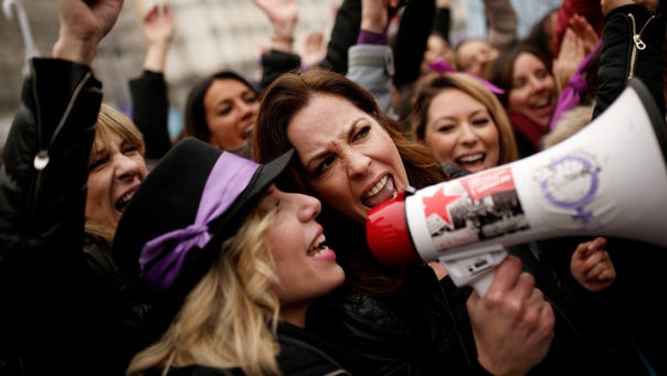 Women shout during a protest at the Sol square during