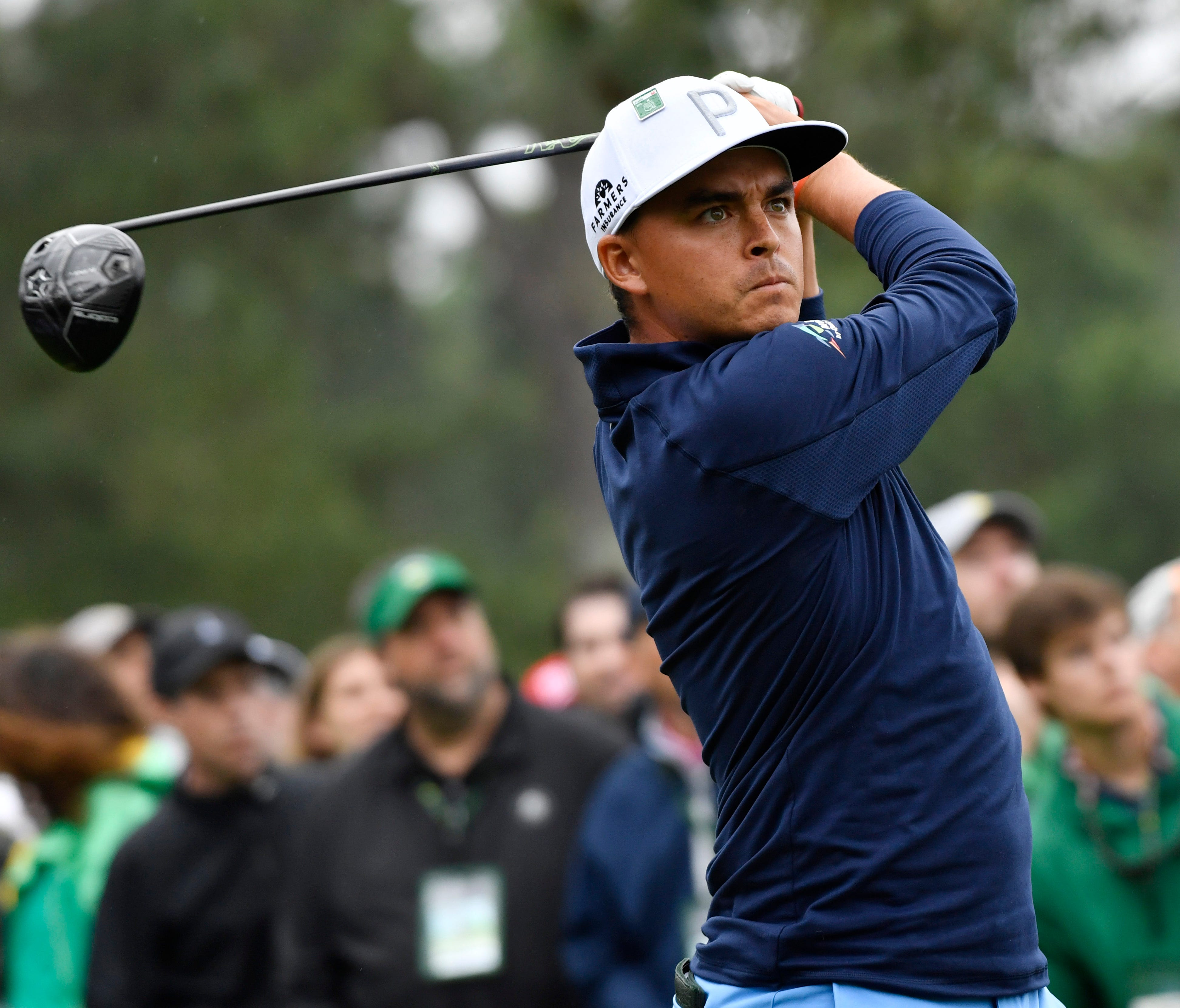 Rickie Fowler hits his tee shot on the 18th hole during the third round of the Masters golf tournament at Augusta National Golf Club.