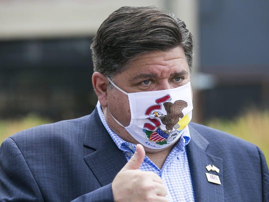 Illinois Gov. J.B. Pritzker meets with people at City Market in Rockford, Ill.