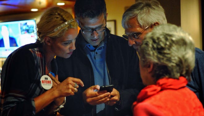 Marielle Ritchie, Jon Ritchie's wife, left, and campaign chairman Garrett Rothman look at results as they come in while waiting at Duke's Riverside in Lemoyne, Tuesday, April 26, 2016. John A. Pavoncello