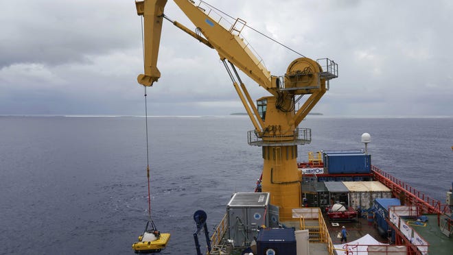 A submersible is lowered into the water during extensive tests to practice the launch and recovery of submersibles onboard the Ocean Zephyr after the British-led Nekton Mission reached the tiny atoll of Alphonse in Seychelles waters.