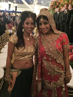 Raela poses with bride Manisha after the ceremony which took place at the Country Club.