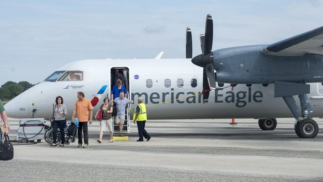 Passengers get off an American Airlines turboprop at the Salisbury-Ocean City: Wicomico Regional Airport.