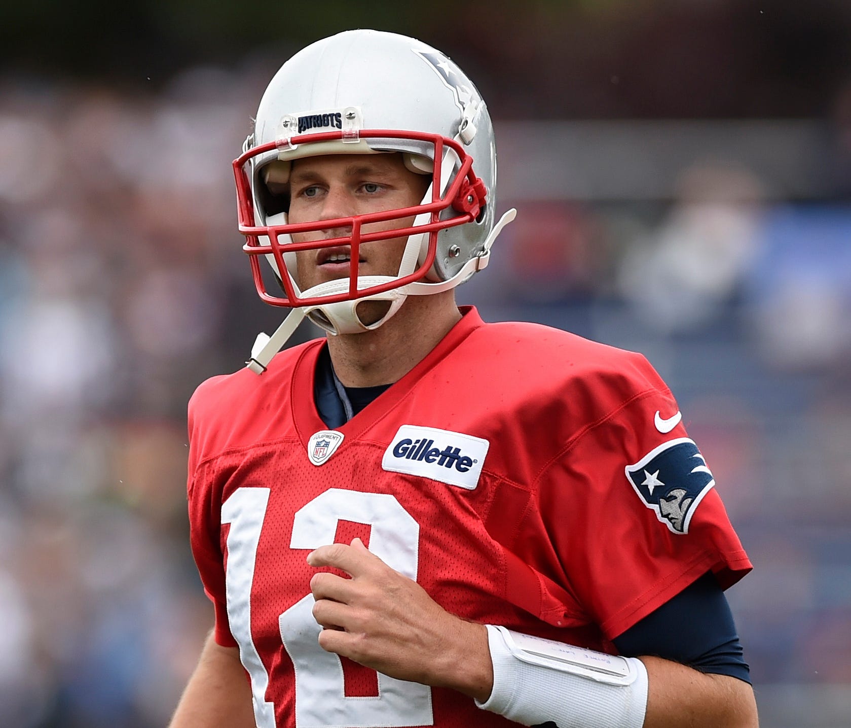Jul 27, 2017; Foxborough, MA, USA; New England Patriots quarterback Tom Brady (12) runs on to the field during training camp at Gillette Stadium. Mandatory Credit: Bob DeChiara-USA TODAY Sports