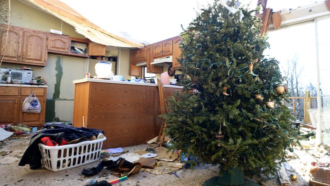 A Christmas tree stands among damage done to a home on Falcon Road in Selmer on Thursday morning, after a tornado passed through the area Wednesday evening. No deaths or injuries were reported.