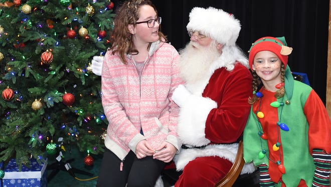 Santa listens to a holiday wish list at the Rehoboth Beach firehouse after the parade.