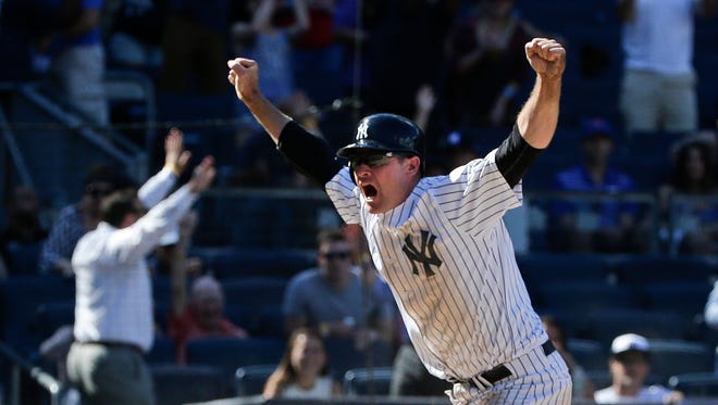 New York Yankees' Chase Headley, left, celebrates after sliding past Texas Rangers relief pitcher Tony Barnette, right, to score the game winning run during the ninth inning of a baseball game Thursday, June 30, 2016, in New York. Headley scored on a passed ball as the Yankees won 2-1.
