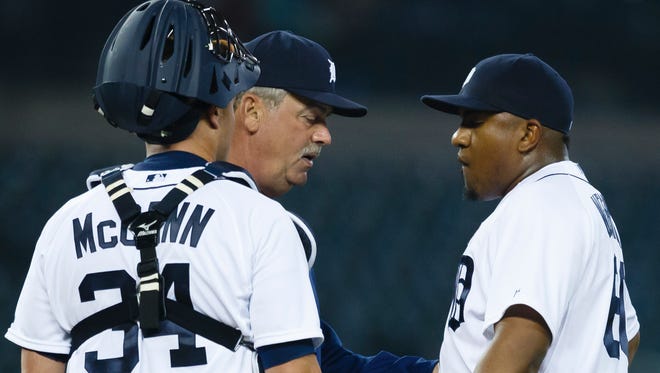 Detroit Tigers relief pitcher Angel Nesbitt, right, talks with pitching coach Jeff Jones and catcher James McCann during the 10th inning against the Kansas City Royals at Comerica Park.