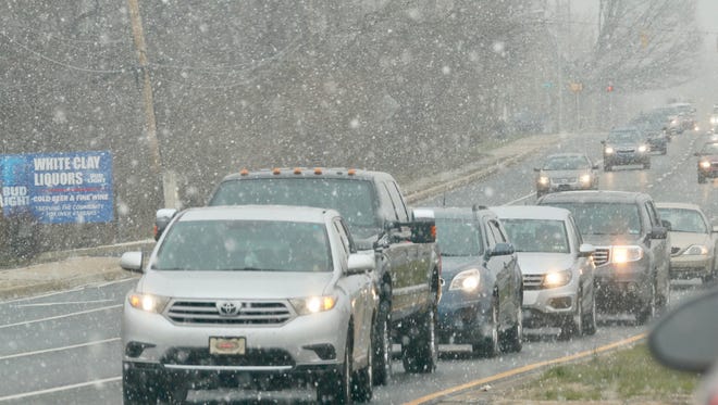 Snow begins to fall on Tuesday morning as motorists make their way along Route 4 near Harmony Road.