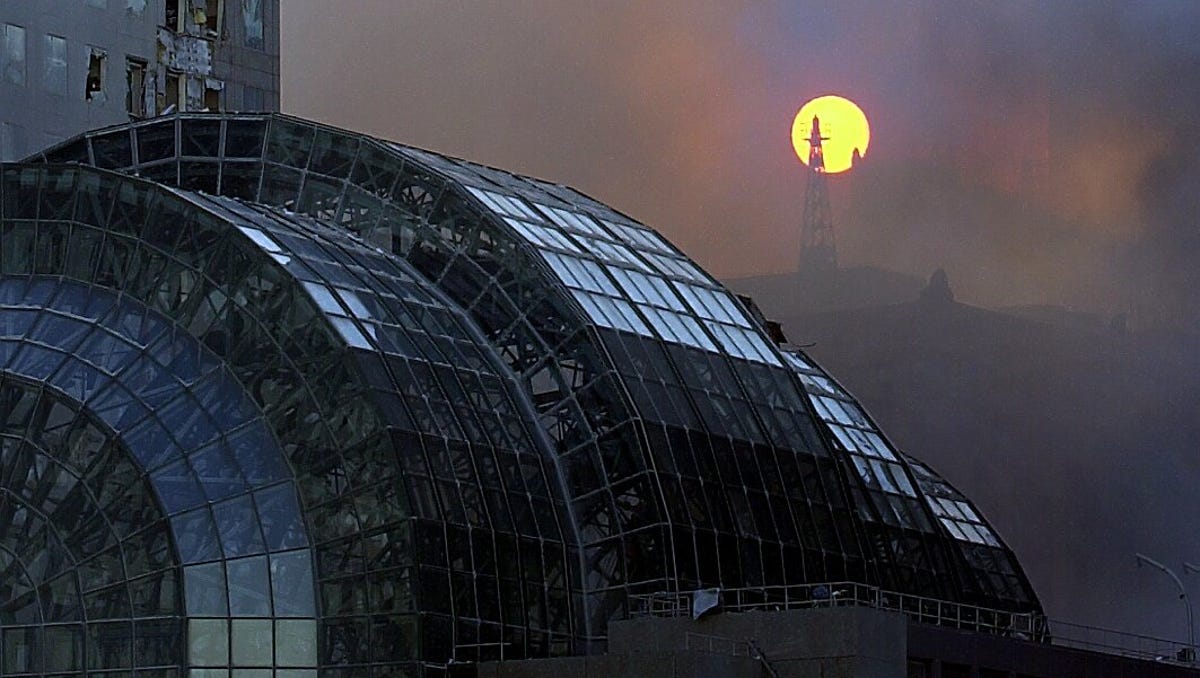 The sun rises over the shattered remains of the Winter Garden at the World Financial Center across from Ground Zero on Sept. 13, 2001.