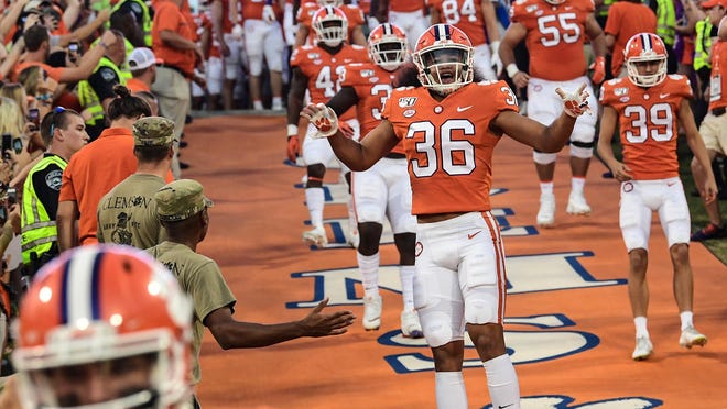 Clemson defensive back Lannden Zanders(36) and teammates run down the hill with teammates before the game at Memorial Stadium in Clemson, South Carolina Saturday, September 21, 2019.