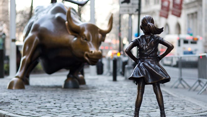 The Charging Bull and Fearless Girl statues sit in New York's financial district. The installation of the bold girl defiantly standing in the bull's path has transformed the meaning of one of New York's best-known public artworks.