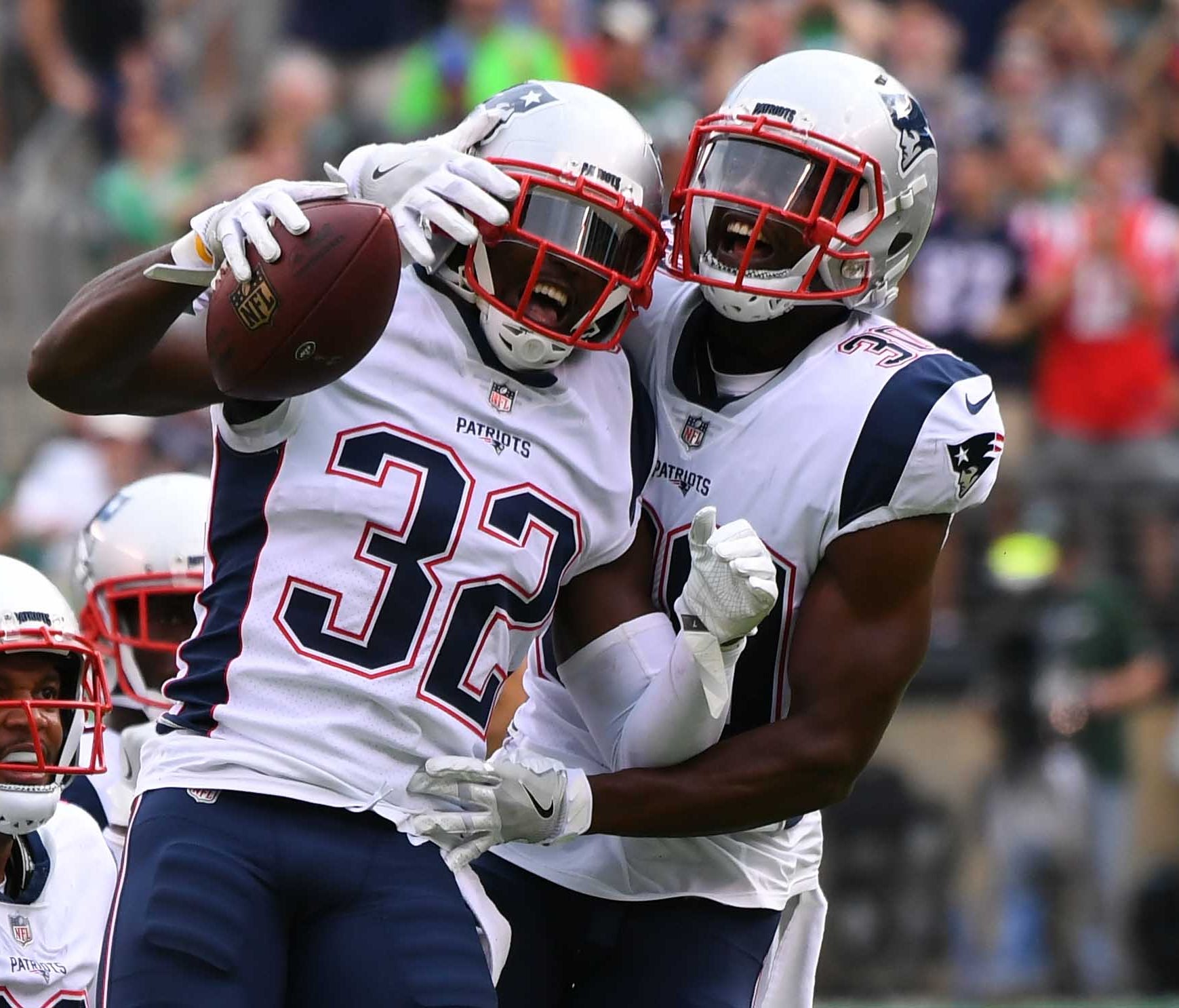 The New England Patriots safety Devin McCourty (32), celebrates with safety Duron Harmon (30) against the New York Jets during the second half at MetLife Stadium.