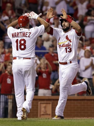 The Cardinals' Matt Carpenter, right, is congratulated by Carlos Martinez after hitting a two-run home run during the third inning against the Milwaukee Brewers on Friday.