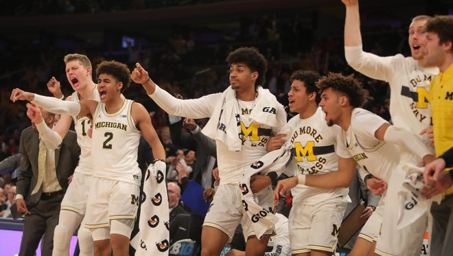 Michigan players react to a play during the second half of the 77-71 overtime win over Iowa in the Big Ten tournament Thursday, March 1, 2018 at Madison Square Garden in New York.