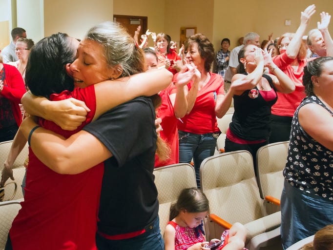 Rita Giddens, left, and Tess Brennan celebrate the Lee County School Board opting out of Common Core testing Wednesday during a school board meeting in Fort Myers. Lee County is the first in Florida to opt out of Common Core testing.