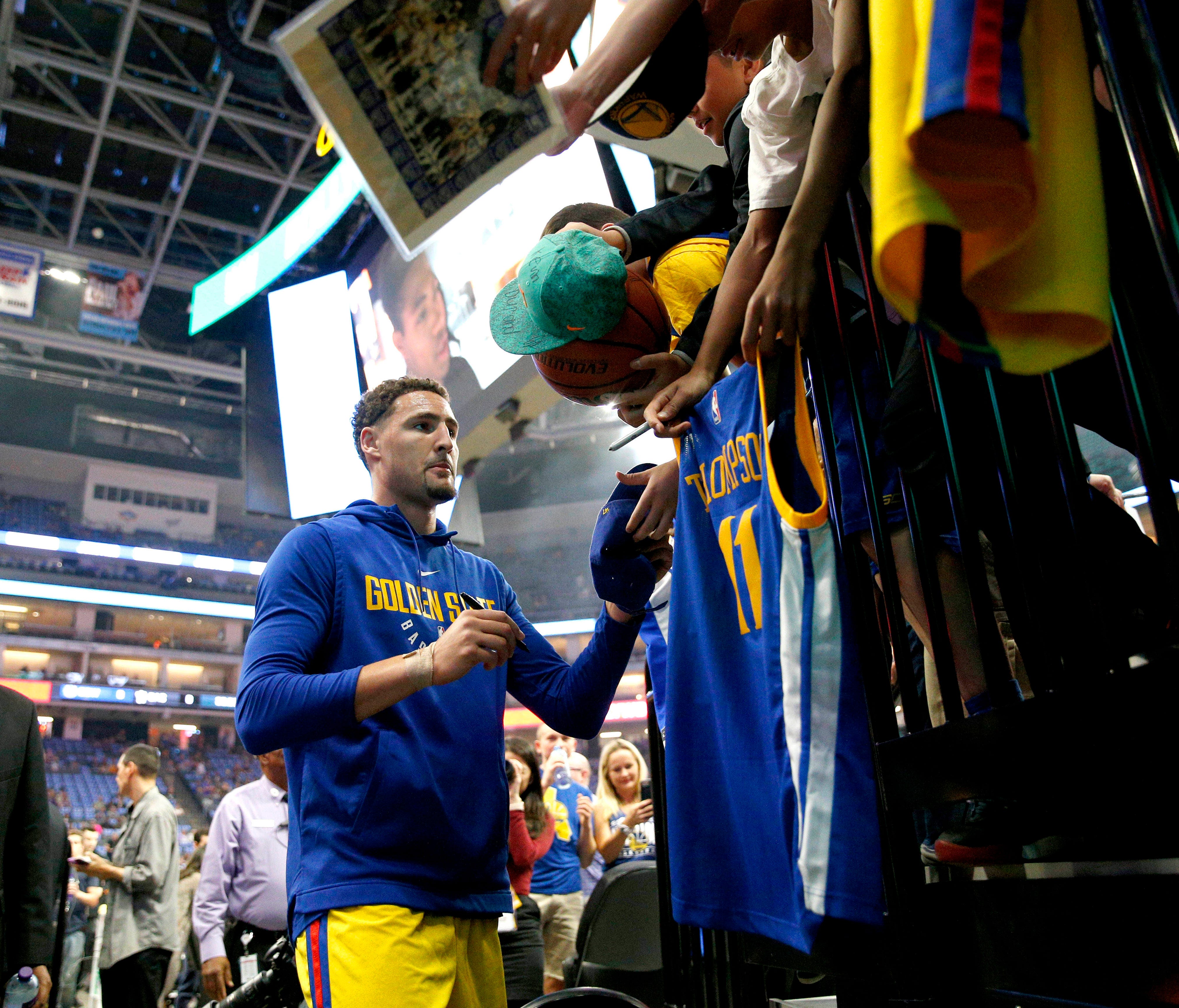 Golden State Warriors guard Klay Thompson (11) signs autographs before the start of a game against the Sacramento Kings at the Golden 1 Center.