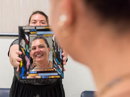 Chantal Matthews of Factory Designs holds a mirror