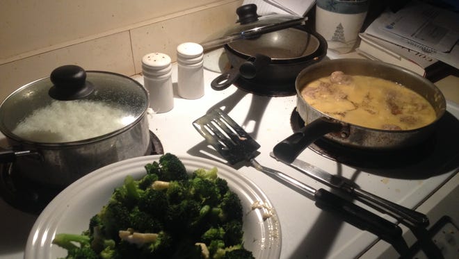 The Oeth family's dinner of rice, steamed broccoli and pork chops with gravy.