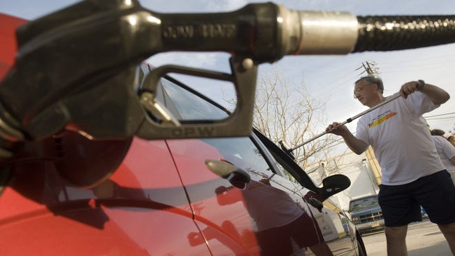 A man washes a car window at Pioneer Gas Station in Washington Township. New Jersey could soon be the only state with a complete ban on self-serve gas.